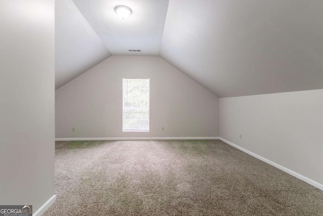 2191 Phillips Rd, Lithonia, GA 30058 - additional living space with carpet, vaulted ceiling, and baseboards
