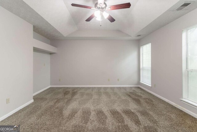 2191 Phillips Rd, Lithonia, GA 30058 - carpeted spare room featuring a raised ceiling, healthy amount of natural light, ceiling fan, and baseboards