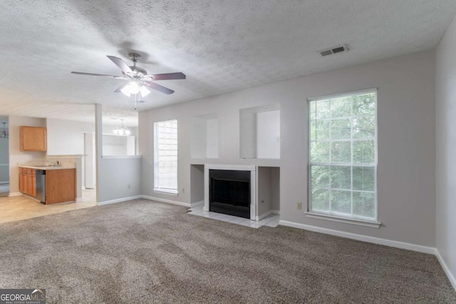 2191 Phillips Rd, Lithonia, GA 30058 - unfurnished living room featuring light carpet, a ceiling fan, a fireplace with flush hearth, baseboards, and a textured ceiling