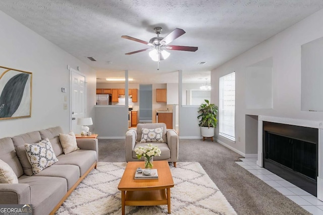 2191 Phillips Rd, Lithonia, GA 30058 - living area with ceiling fan, light colored carpet, a fireplace with flush hearth, baseboards, and a textured ceiling