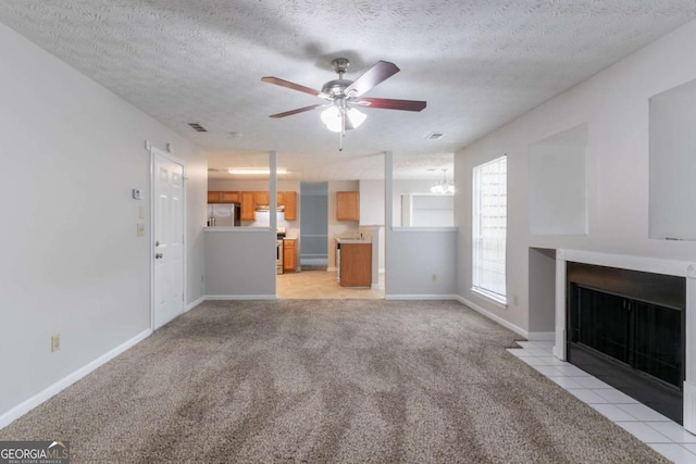 2191 Phillips Rd, Lithonia, GA 30058 - unfurnished living room with ceiling fan, light carpet, a fireplace with flush hearth, a textured ceiling, and baseboards
