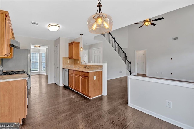535 Watercress Dr, Woodstock, GA 30188 - kitchen with stainless steel appliances, a ceiling fan, baseboards, and dark wood-style floors