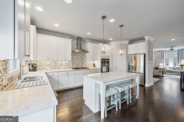 4202 Morrison Way Unit 9, Atlanta, GA 30341 - kitchen featuring appliances with stainless steel finishes, wall chimney exhaust hood, backsplash, a sink, and a kitchen island