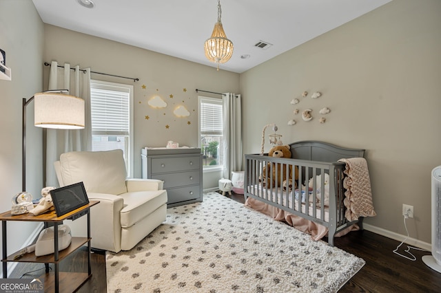 4202 Morrison Way Unit 9, Atlanta, GA 30341 - bedroom featuring a chandelier, wood finished floors, baseboards, and a nursery area