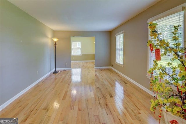 2808 Peeler Rd, Dunwoody, GA 30360 - unfurnished room featuring plenty of natural light, light wood finished floors, and baseboards
