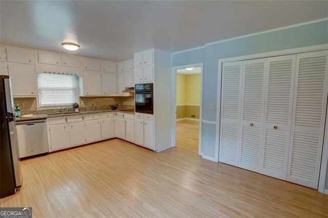 2808 Peeler Rd, Dunwoody, GA 30360 - kitchen with appliances with stainless steel finishes, light wood-style flooring, and white cabinetry
