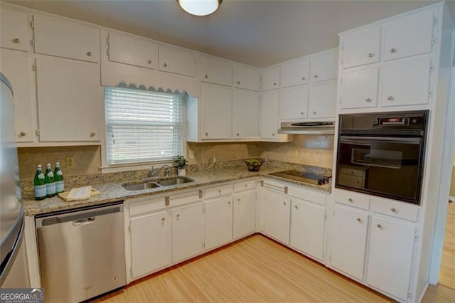 2808 Peeler Rd, Dunwoody, GA 30360 - kitchen featuring black appliances, a sink, white cabinetry, light wood-type flooring, and under cabinet range hood