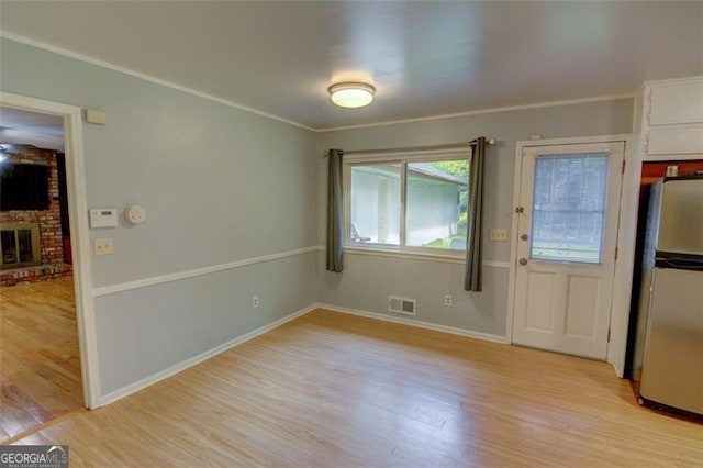 2808 Peeler Rd, Dunwoody, GA 30360 - unfurnished dining area with light wood finished floors, a fireplace, baseboards, and ornamental molding