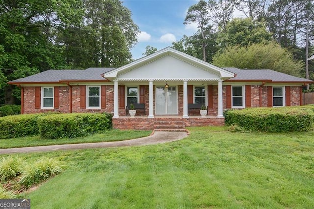 2808 Peeler Rd, Dunwoody, GA 30360 - view of front of home featuring a front yard, brick siding, and covered porch