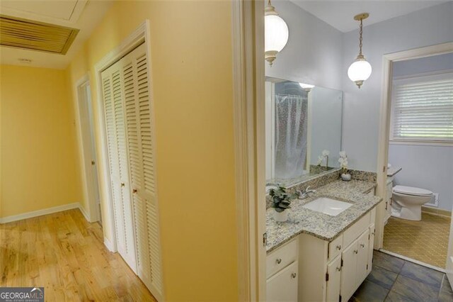 2808 Peeler Rd, Dunwoody, GA 30360 - full bath with vanity, toilet, a closet, and baseboards