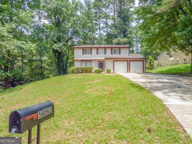 5092 Stone Trce, Stone Mountain, GA 30083 - view of front facade with a front yard, concrete driveway, and a garage