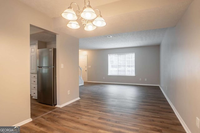 5092 Stone Trce, Stone Mountain, GA 30083 - unfurnished dining area with a chandelier, dark wood-style floors, and baseboards