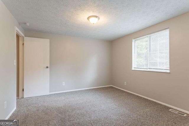 5092 Stone Trce, Stone Mountain, GA 30083 - carpeted spare room with a textured ceiling, baseboards, and a smoke detector