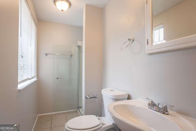 5092 Stone Trce, Stone Mountain, GA 30083 - bathroom with a sink, toilet, a shower stall, tile patterned floors, and baseboards