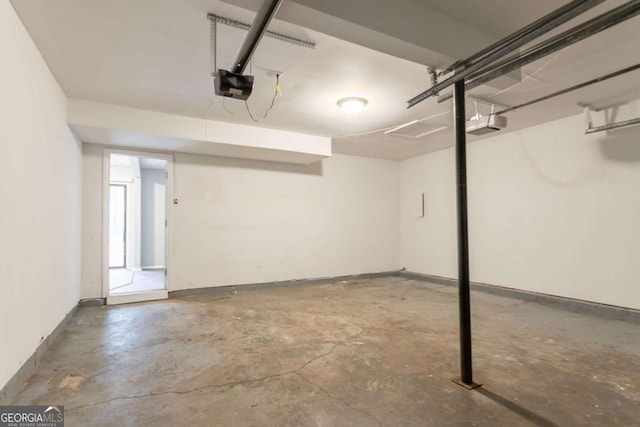 5092 Stone Trce, Stone Mountain, GA 30083 - garage featuring a garage door opener and baseboards