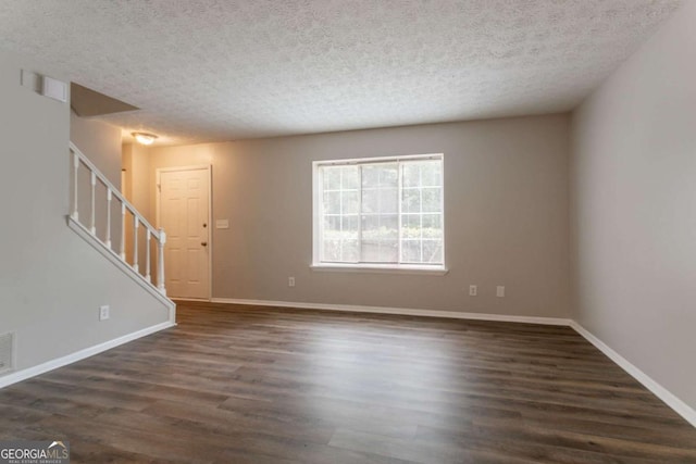 5092 Stone Trce, Stone Mountain, GA 30083 - unfurnished living room featuring stairs, a textured ceiling, dark wood finished floors, and baseboards