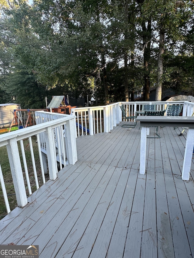 517 Pebble Pt, Loganville, GA 30052 - wooden terrace featuring a playground and view of scattered trees
