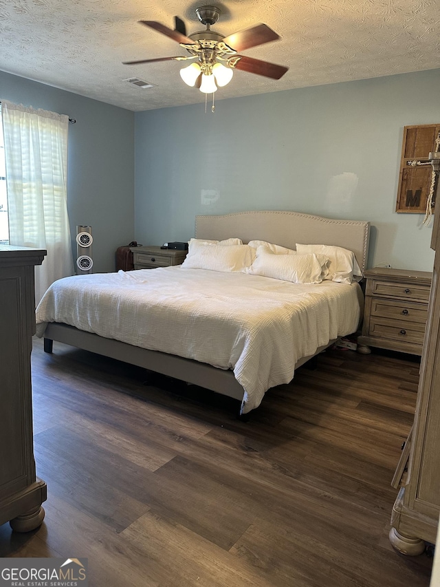 517 Pebble Pt, Loganville, GA 30052 - bedroom featuring dark wood finished floors, a textured ceiling, and ceiling fan