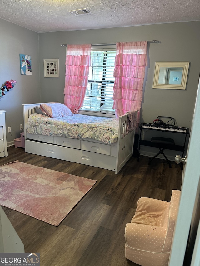 517 Pebble Pt, Loganville, GA 30052 - bedroom with dark wood finished floors and a textured ceiling