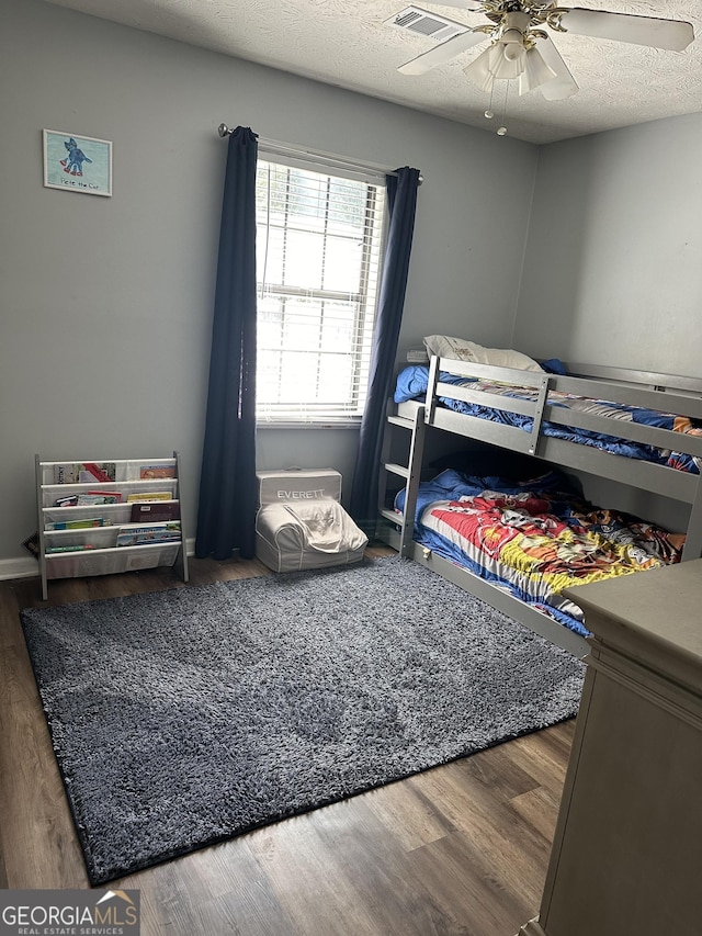517 Pebble Pt, Loganville, GA 30052 - bedroom featuring wood finished floors, a ceiling fan, and a textured ceiling