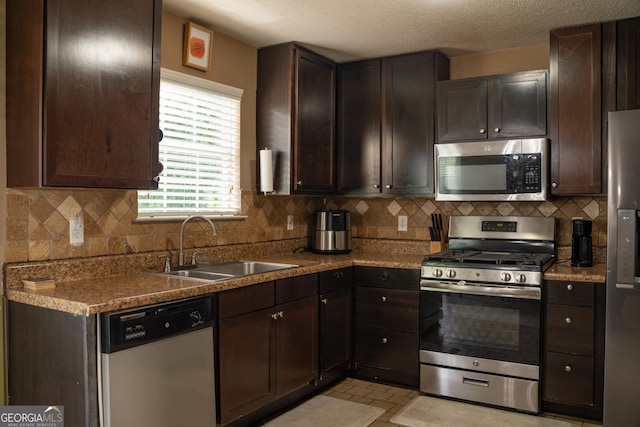 3269 N Winds Trl, Douglasville, GA 30135 - kitchen with stainless steel appliances, a sink, dark brown cabinets, and decorative backsplash