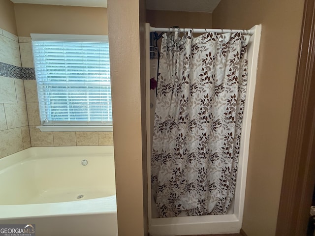 3269 N Winds Trl, Douglasville, GA 30135 - bathroom featuring a shower with shower curtain and a garden tub