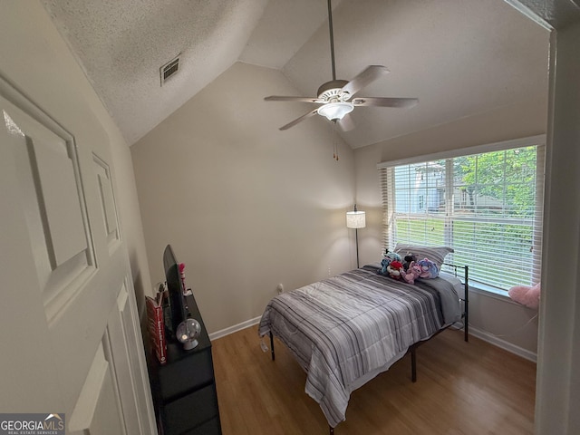 3269 N Winds Trl, Douglasville, GA 30135 - bedroom with vaulted ceiling, baseboards, wood finished floors, a textured ceiling, and ceiling fan