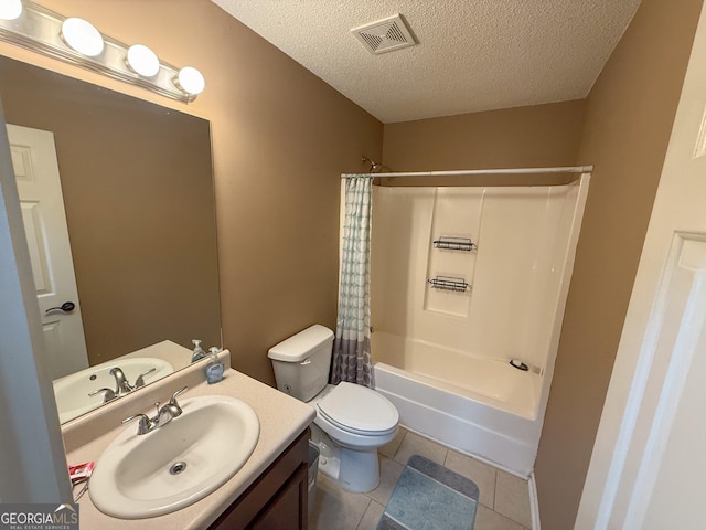 3269 N Winds Trl, Douglasville, GA 30135 - full bathroom with a textured ceiling, vanity, toilet, shower / tub combo with curtain, and tile patterned flooring