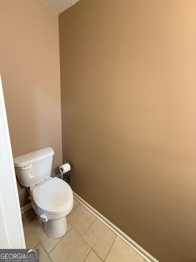 3269 N Winds Trl, Douglasville, GA 30135 - bathroom with toilet, baseboards, tile patterned floors, and a textured ceiling