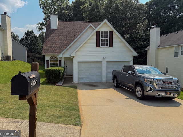 3269 N Winds Trl, Douglasville, GA 30135 - view of front of house featuring a front yard, concrete driveway, a shingled roof, and central AC unit