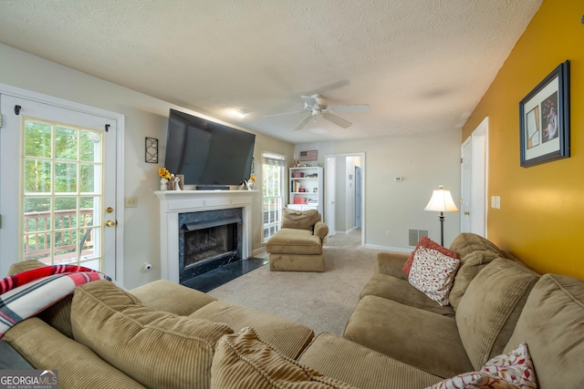 1885 N Creek Cir, Alpharetta, GA 30009 - living area with a textured ceiling, a premium fireplace, a ceiling fan, and carpet