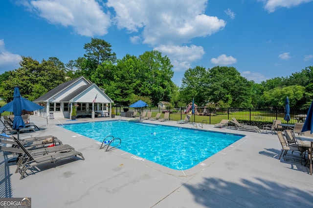 1885 N Creek Cir, Alpharetta, GA 30009 - community pool featuring a patio and view of wooded area