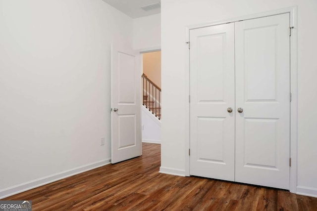 1279 Day Dr, Bogart, GA 30622 - unfurnished bedroom featuring dark wood-style flooring, a closet, and baseboards