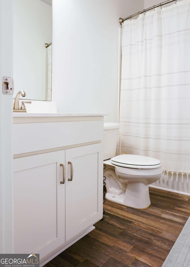 1279 Day Dr, Bogart, GA 30622 - bathroom featuring toilet, wood finished floors, vanity, and a shower with curtain