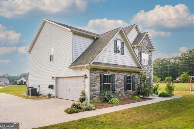 1279 Day Dr, Bogart, GA 30622 - view of front of property with an attached garage, stone siding, driveway, and central air condition unit