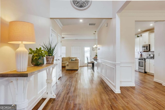 1279 Day Dr, Bogart, GA 30622 - hall featuring ornamental molding, light wood-type flooring, a decorative wall, and recessed lighting