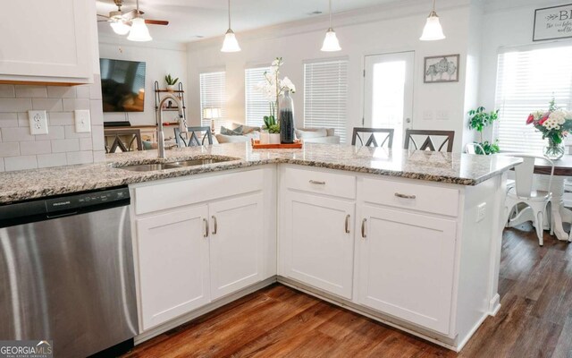 1279 Day Dr, Bogart, GA 30622 - kitchen with dishwasher, a sink, plenty of natural light, decorative backsplash, and ornamental molding