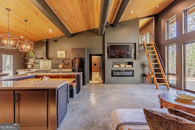 168 State Line Rd, Cloudland, GA 30731 - kitchen with wood ceiling, a center island, fridge with ice dispenser, wall chimney range hood, and finished concrete flooring