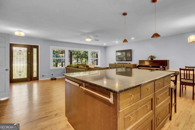 4794 Glenbonnie Ct, Dunwoody, GA 30360 - kitchen with light wood-style flooring, ceiling fan, a center island, open floor plan, and hanging light fixtures