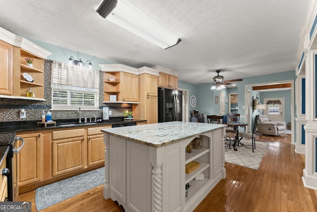 8958 Bill Savage Rd, Lula, GA 30554 - kitchen featuring open shelves, black fridge, a sink, a textured ceiling, and backsplash