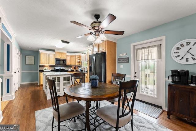 8958 Bill Savage Rd, Lula, GA 30554 - dining space with ceiling fan, wood finished floors, and baseboards