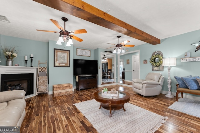 8958 Bill Savage Rd, Lula, GA 30554 - living room featuring a ceiling fan, beam ceiling, baseboards, and wood-type flooring