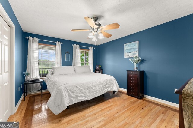 8958 Bill Savage Rd, Lula, GA 30554 - bedroom featuring light wood-style flooring, baseboards, and ceiling fan