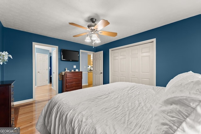8958 Bill Savage Rd, Lula, GA 30554 - bedroom featuring baseboards, a closet, light wood finished floors, and a ceiling fan