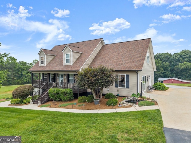 8958 Bill Savage Rd, Lula, GA 30554 - cape cod home with a porch, a front yard, a shingled roof, and driveway