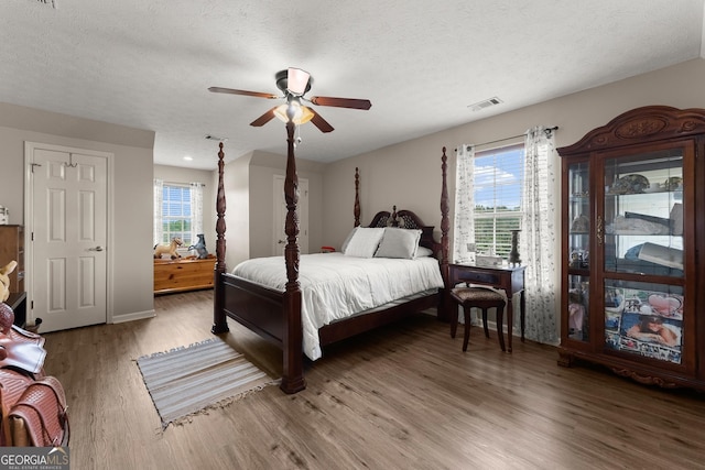 8958 Bill Savage Rd, Lula, GA 30554 - bedroom with wood finished floors, a textured ceiling, baseboards, and a ceiling fan