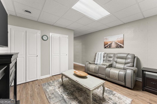 8958 Bill Savage Rd, Lula, GA 30554 - living area featuring a drop ceiling, light wood-type flooring, and baseboards