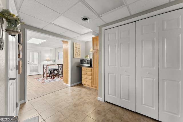8958 Bill Savage Rd, Lula, GA 30554 - bedroom with a paneled ceiling, baseboards, a closet, and light tile patterned floors