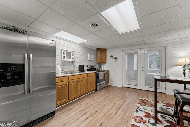 8958 Bill Savage Rd, Lula, GA 30554 - kitchen featuring appliances with stainless steel finishes, a sink, a paneled ceiling, french doors, and light wood finished floors