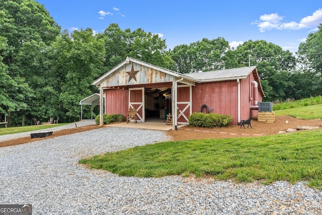 8958 Bill Savage Rd, Lula, GA 30554 - view of front of home with central AC unit, an outbuilding, gravel driveway, a detached carport, and a front yard